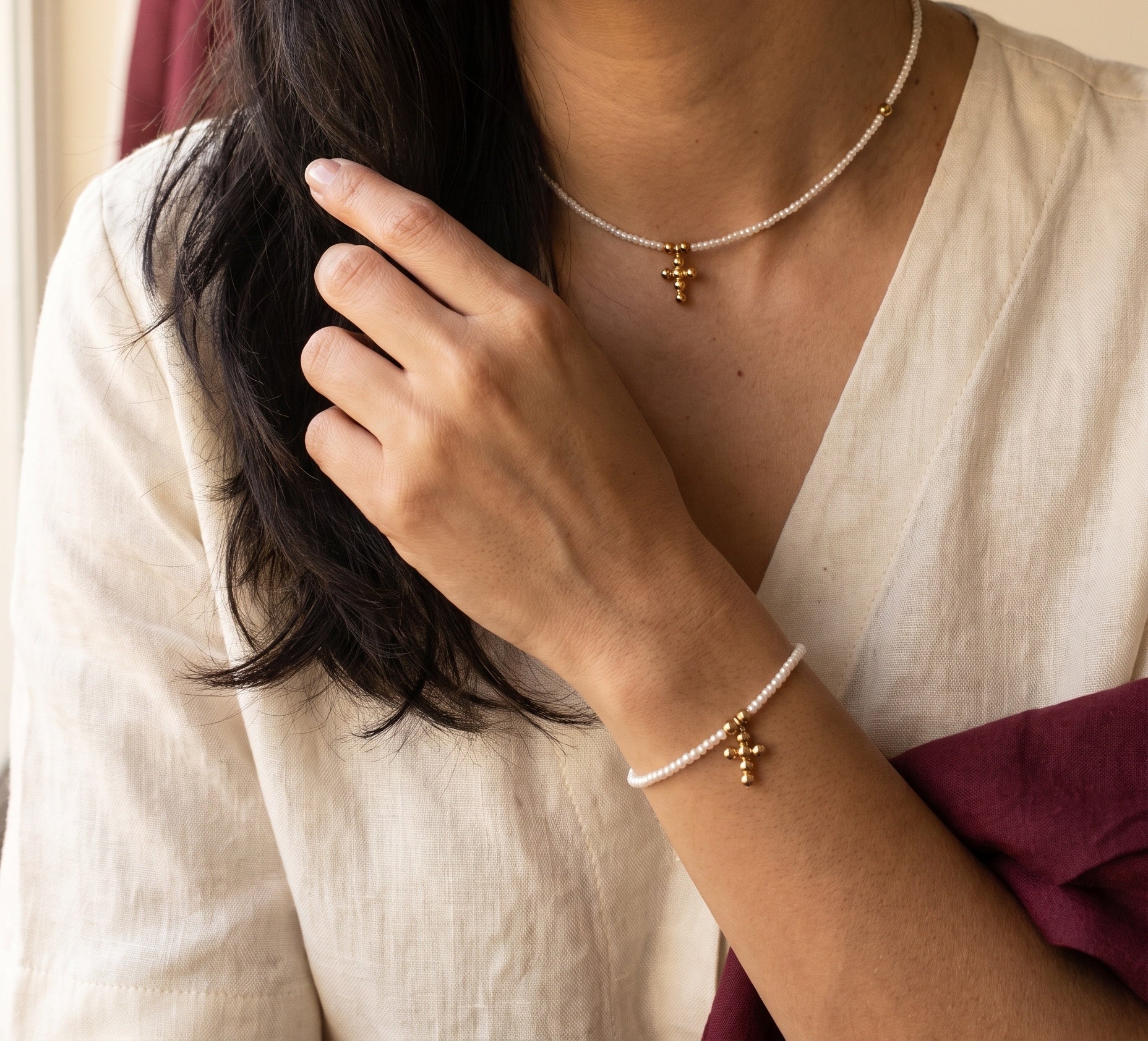 Perla Santa — collar y pulsera cruz perla natural, imagen editorial